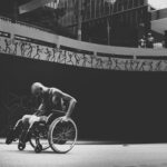 A main road with a man in a wheelchair.
