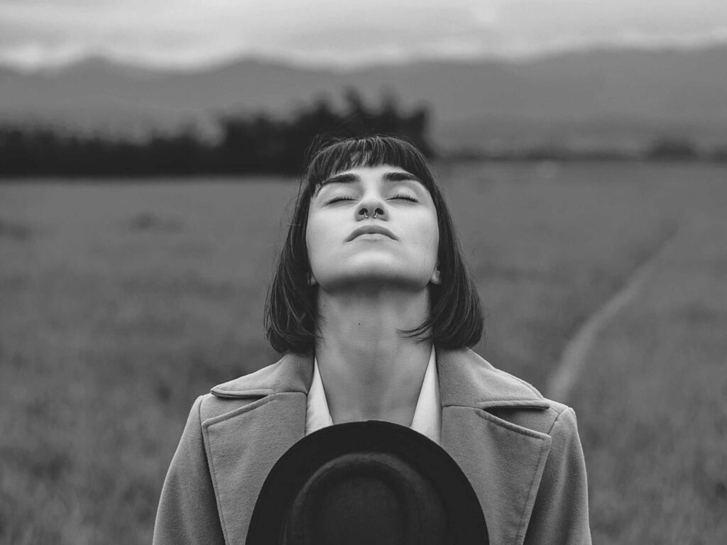A woman taking a deep breath